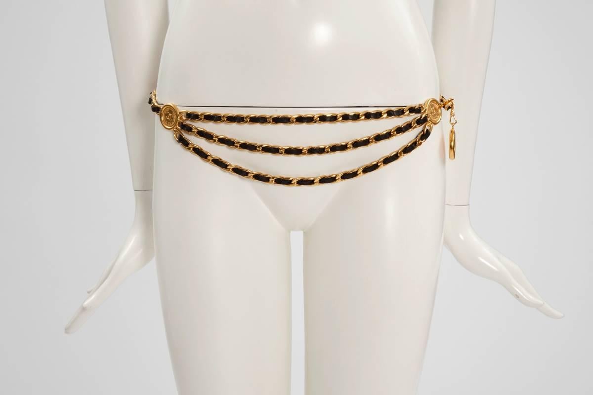 Early 90's Chanel triple gold plated chain waist belt with black lambskin leather woven throughout. Large 