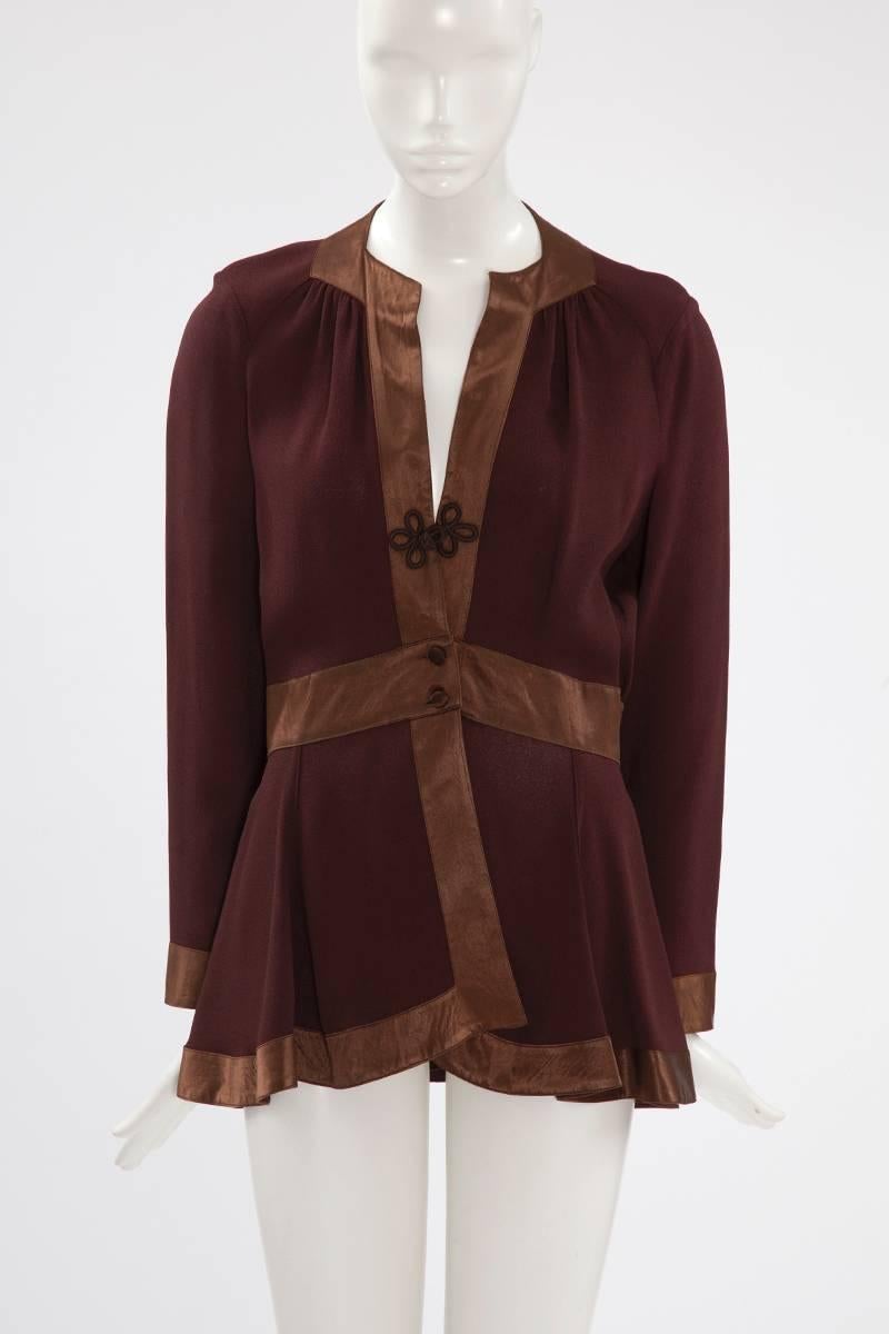 Ossie Clark shirt-top from the seventies, very representative of his design featuring a beautiful contrast between the dark brown matte moss crepe body and the satin details. The unlined top closes with a brandeburg knot and two covered buttons. The