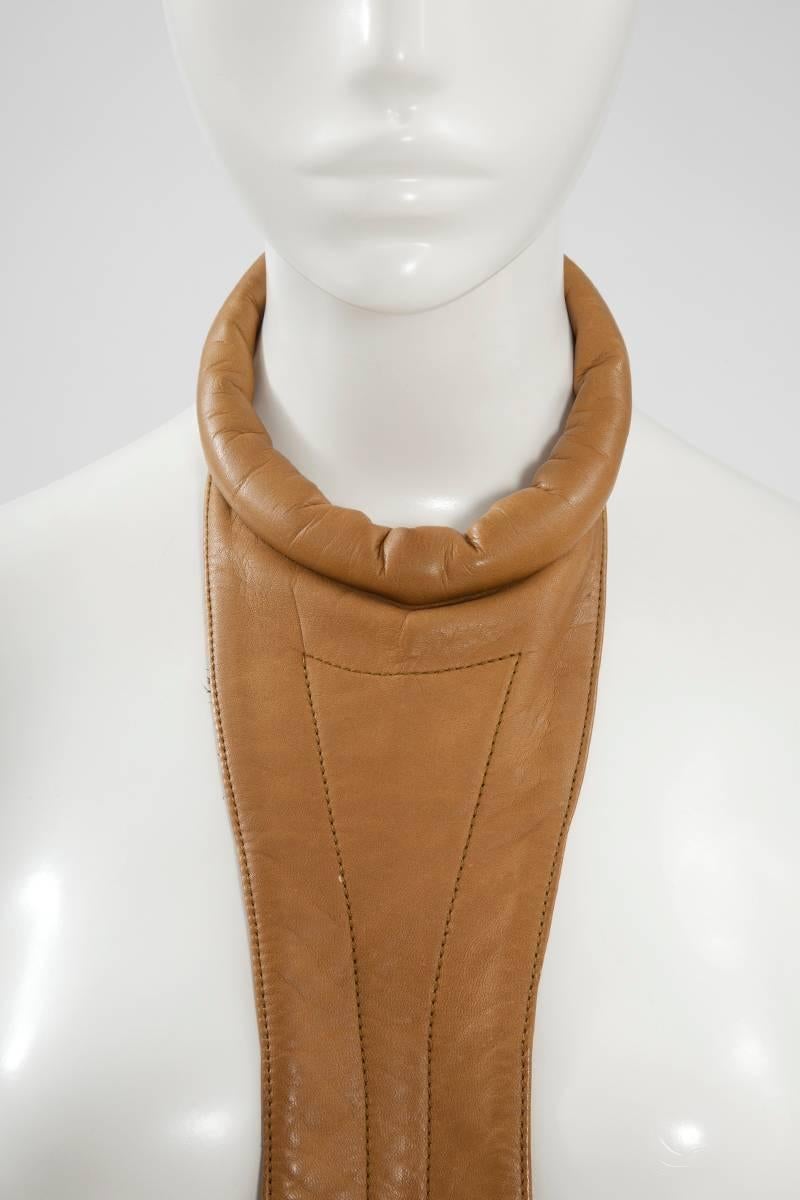 A fantastic and rare example of Pierre Cardin’s futuristic design, this low waist mini dress is the perfect way of introducing his characteristic space-age touch into your everyday wardrobe. Constructed in tan leather, this late 60's - early 70's