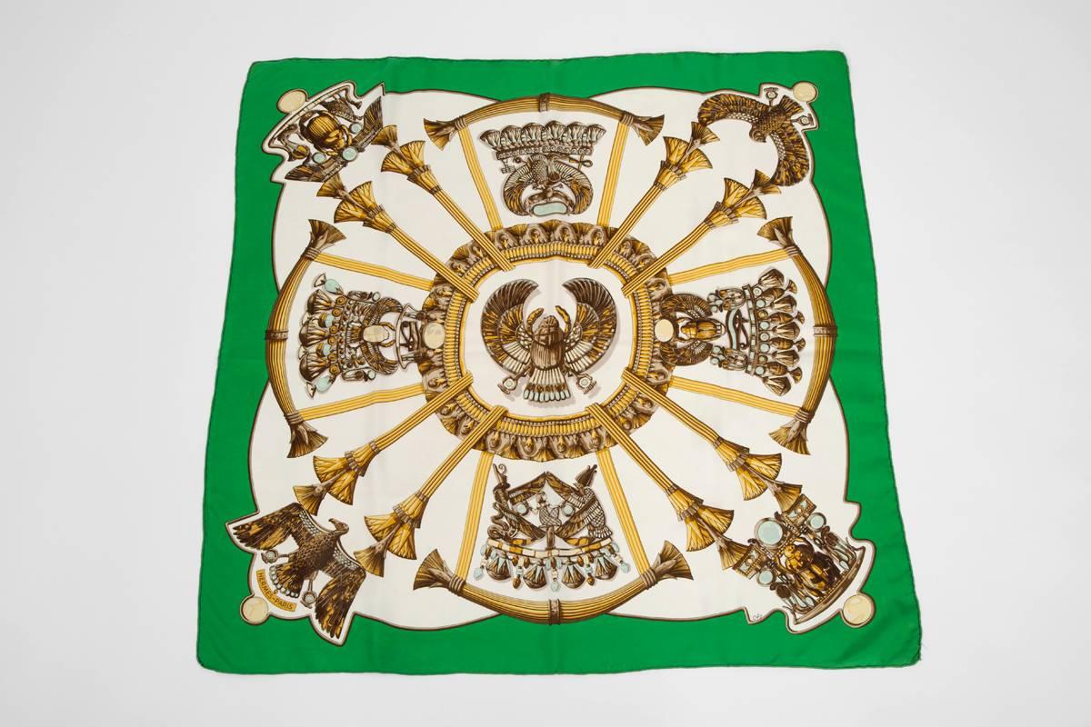 This bold white carré with golden Egyptian symbols was designed by a favourite Hermes artist, Caty Latham. First issue in 1970, this silk twill scarf has been reissued in 1999. Original Hermes box not included.

Dimensions : approx. 90 x 90 cm