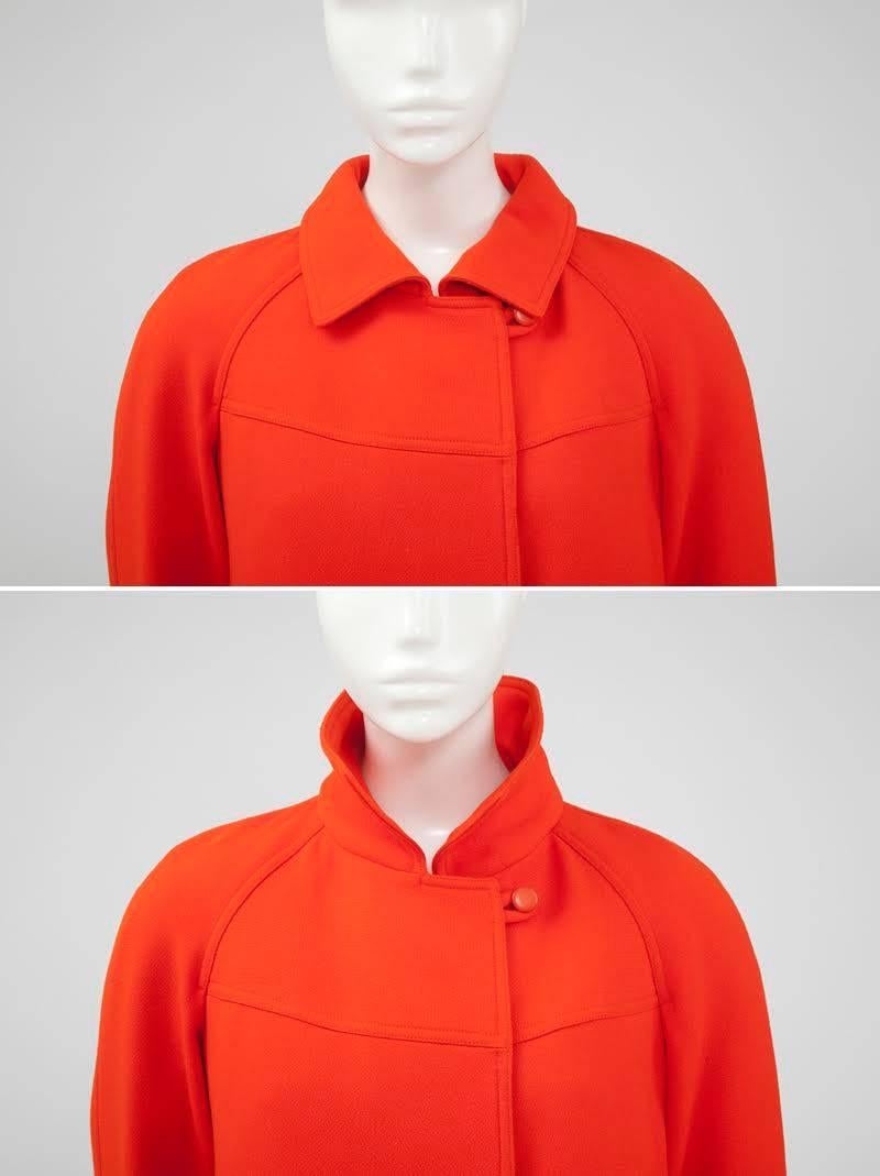 Perfect for the cooler season, this versatile 70’s Courrèges ensemble is made up of trousers and a matching coat. Constructed in the emblematic "Courrèges orange" wool, both pieces are wearable and chic alone. Featuring raglan sleeves, a