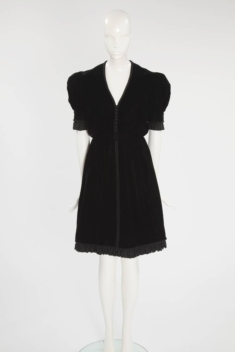 Perfect for everything from cocktail parties to dinners, this wonderful 60’s Jean Patou “little black dress” has a “dirndl” feel. Constructed in black velvet, the dress features puffed shoulders and a ruffled mate silk taffeta around the sleeves and