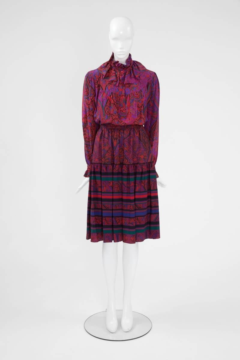 A beautiful example of YSL late 70’s Eastern culture inspired, this skirt suit consists of a silk blouse and a matching wool skirt. Both pieces feature a rich vibrant colourful paisley pattern. Labelled a French size 44 (US 12), the blouse-tunic has