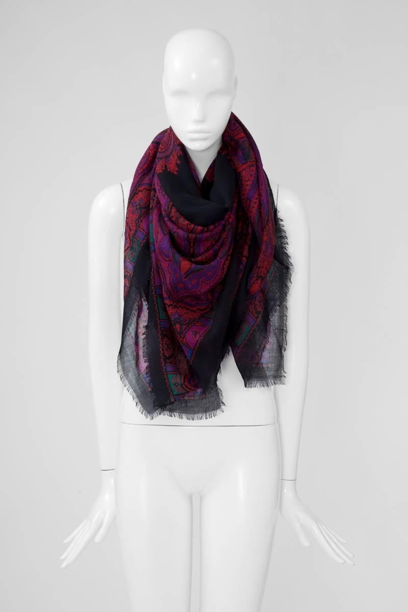 This wonderful large 70's YSL stole, beautifully patterned with Paisley motifs, is providing an effortlessly bohemian « hippie chic » feel to any outfit. Cut from light wool in dark shades of fuchsia, purple, green and black, it is large enough to