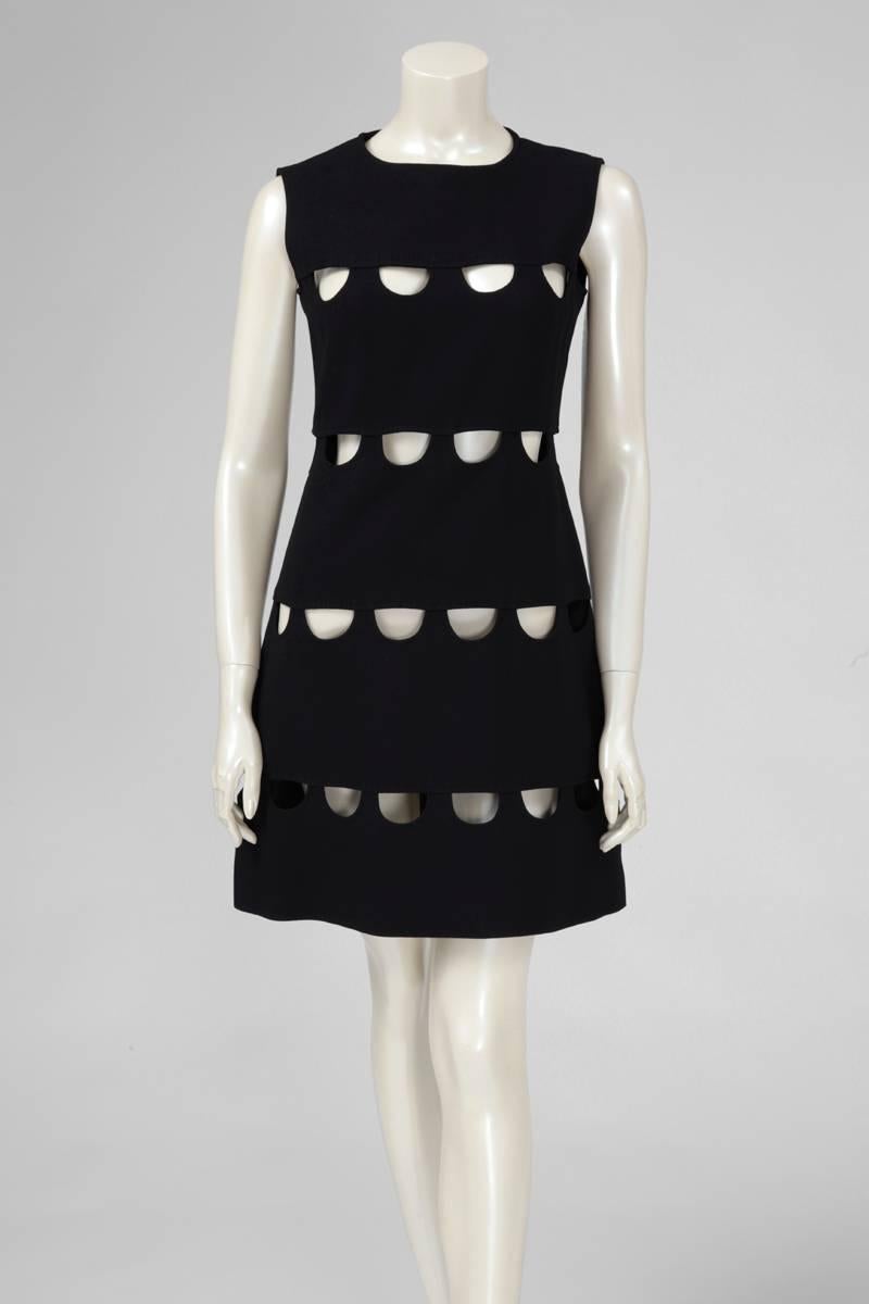 A stunningly sexy 60’s mini dress, this Louis Féraud sleeveless piece is constructed in soft black wool and features geometric cutaway details at the front. Fully lined and labelled a size 42, the dress runs small to size. Concealed zip closure at