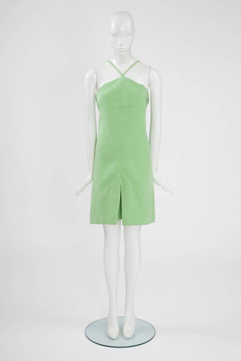 Constructed in a refined shade of mint green silk, this 60’s “attributed to” Pierre Cardin dress is just perfect for summer. The simple line of this shift dress, with a center front slit at the bottom, enhances its unusual neckline. Straight straps