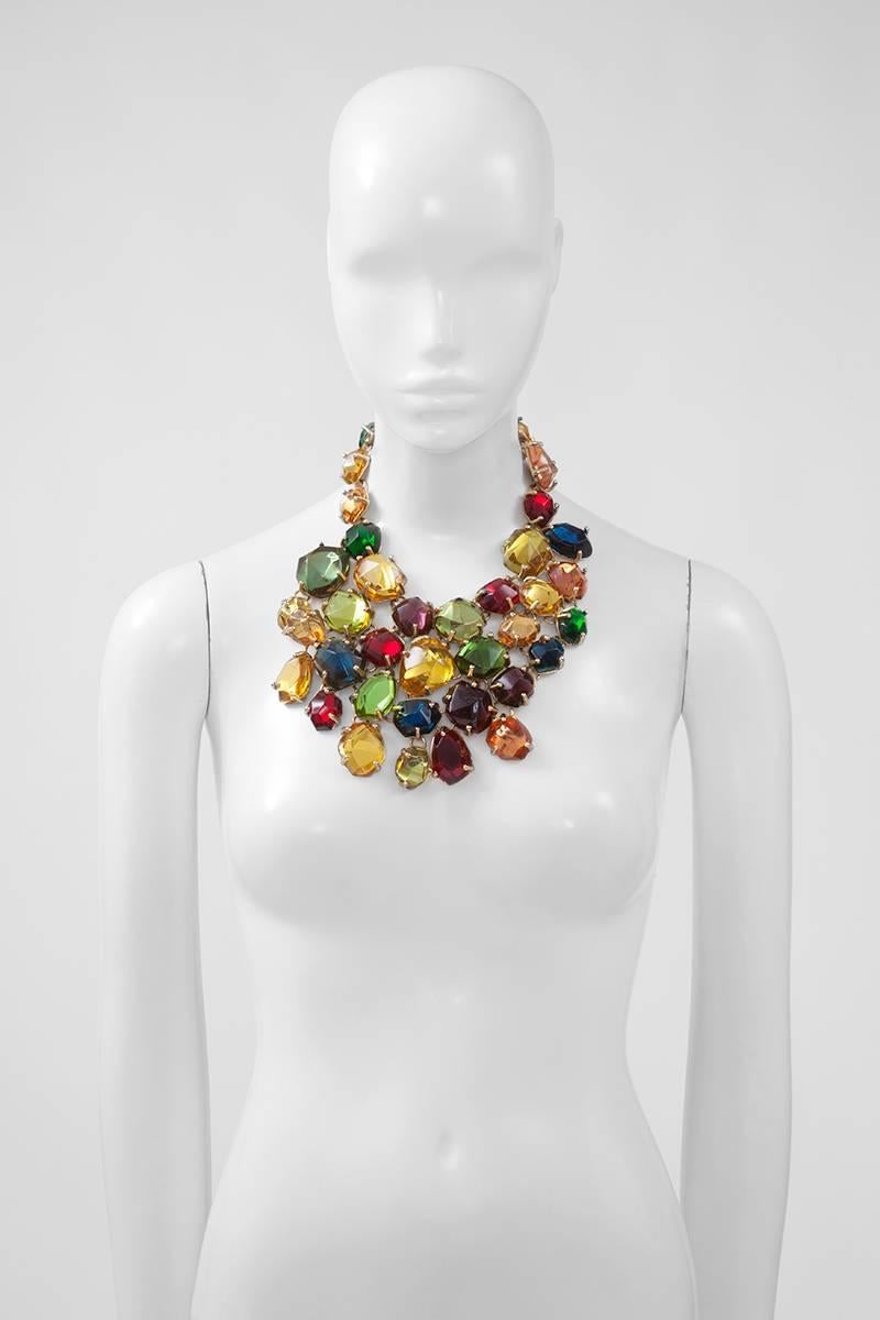 Dramatic Yves Saint Laurent gilt metal bib necklace with irregular large bright multi-colored resin stones in clawed settings. Hook and eye closure at the back. The length of the necklace is adjustable and features the “YSL” logo tag (see picture