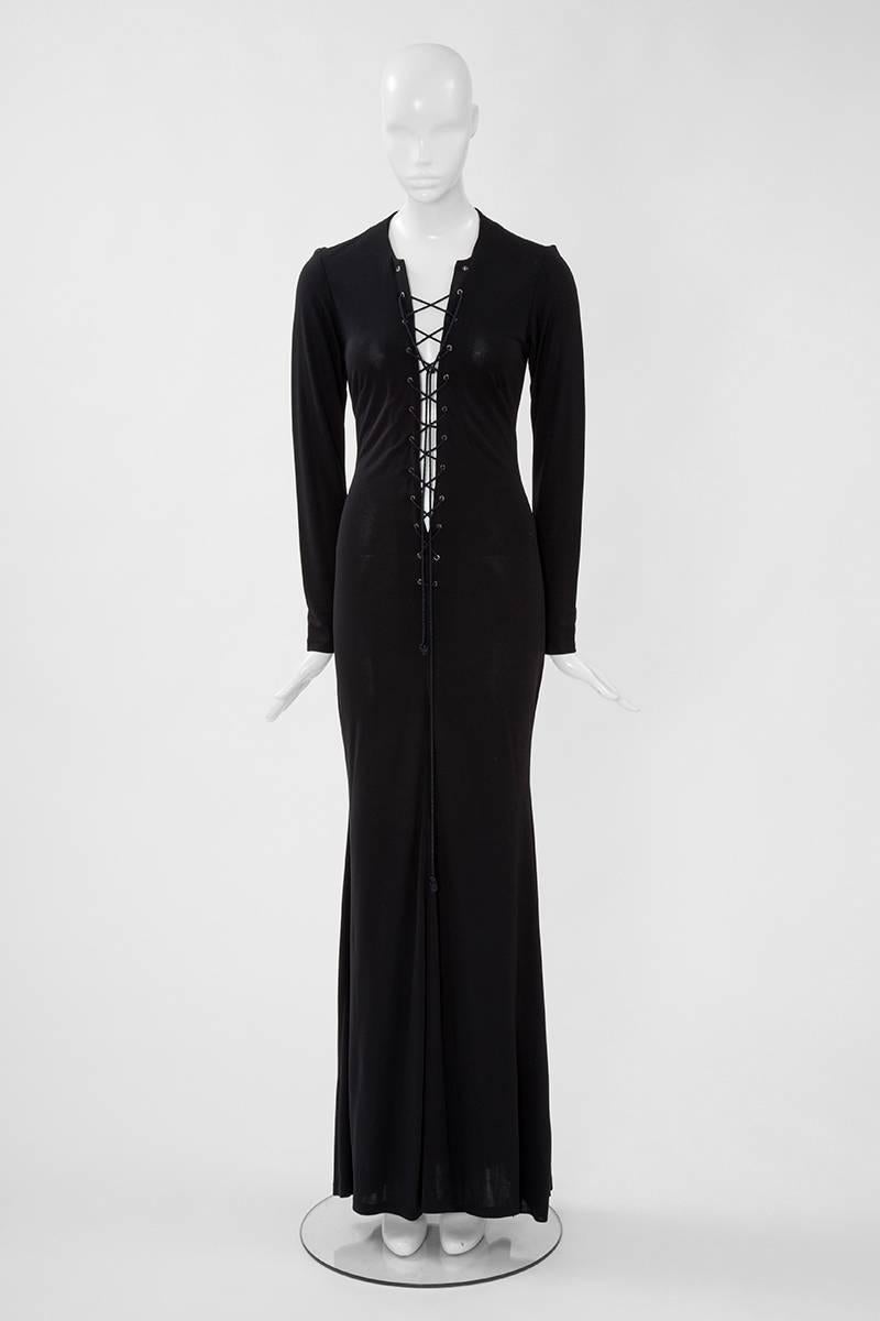 Reminiscent of the iconic saharienne, this YSL black lace up jersey maxi dress could be incredibly sexy ! Enhancing graciously the feminine silhouette, just slip on to wear this versatile piece. This very dress was used for the official shooting