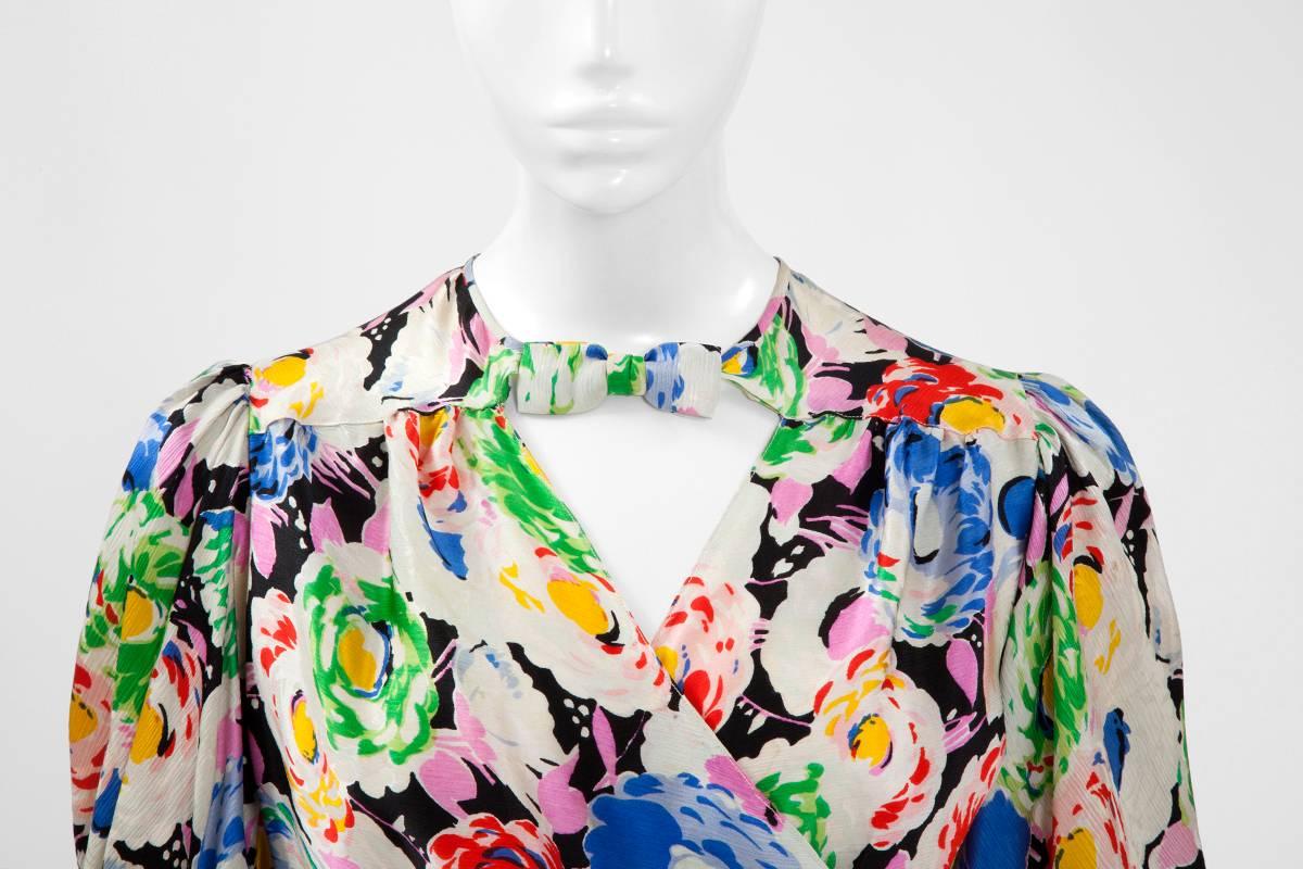 As elegant and relevant as it was nearly 90 years ago, this wonderful bias-cut 30’s wrap maxi dress is made of a colourful peonies print silk. The dress has a V-neckline, which fastens high on the shoulders line with an adorable snap closure bow.