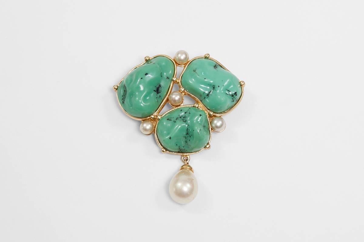Vintage signed YSL brooch featuring three faux turquoises set in gilt metal, highlighted with five faux pearls, one of which is baroque style. To be worn casual on a military jacket or smart on a blouse !

Dimensions : 
Max height approx. 7.1 cm
