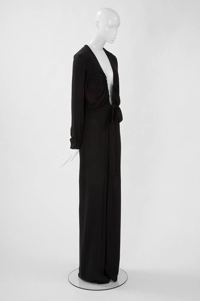 Sexy and elegant, this Chloé jumpsuit will provide a terrific alternative to a traditional gown for evening events. Constructed in a refined black silk crepe, the jumpsuit features a softly draped deep neckline which goes nearly until the navel ! It