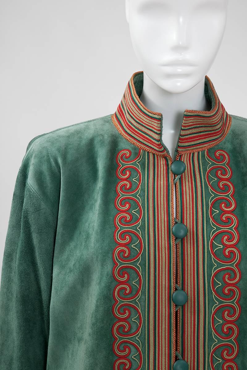 Refined late 70's - early 80’s YSL celadon green suede jacket with mandarin collar featuring an elaborate green and coral red soutache embroidery. An elegant burned orange passementerie trims it all around the edge and the cuffs. It comes together