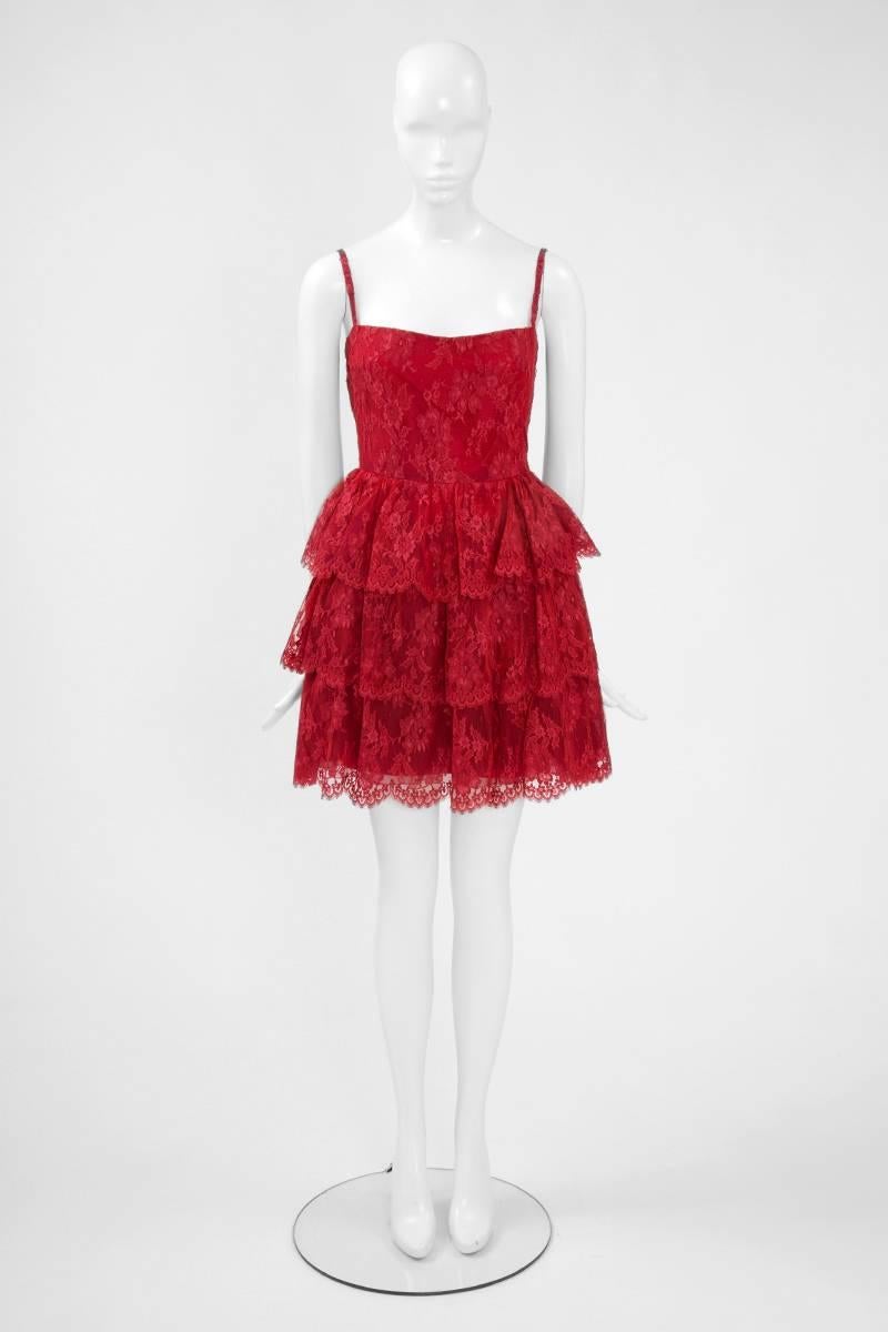 This 80’s Torrente two-piece ensemble is the perfect balance between being playful and sophisticated. Constructed in refined cherry-red “Calais” lace, this mini dress features a slim bodice and flares out at the waist into a tiered ruffled skirt.