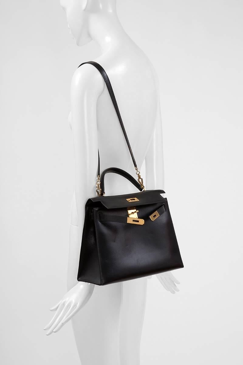 Timeless 1988 Hermès Kelly Sellier handbag in black box calfskin with gold-plated hardware. Tonal stitching. The interior is lined with matching black goat leather. One zip pocket and two patch/open pockets on the opposite side. The bag comes with