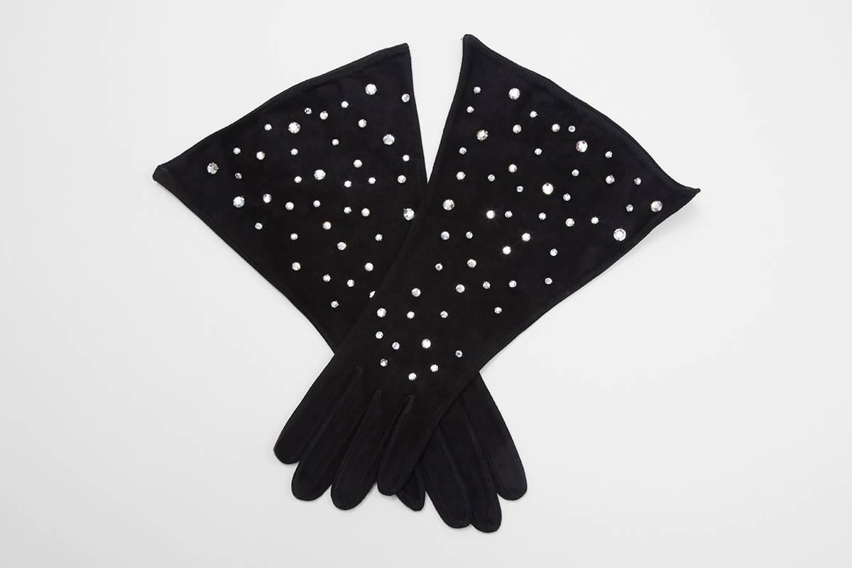 Crafted in France from velvety suede, these unlined YSL black gauntlets are embellished with faceted rhinestones. The flared cut ensures they will fit neatly over the cuffs of either a jacket or a coat. Stamped inside size 7.5 (approx. size M) ;