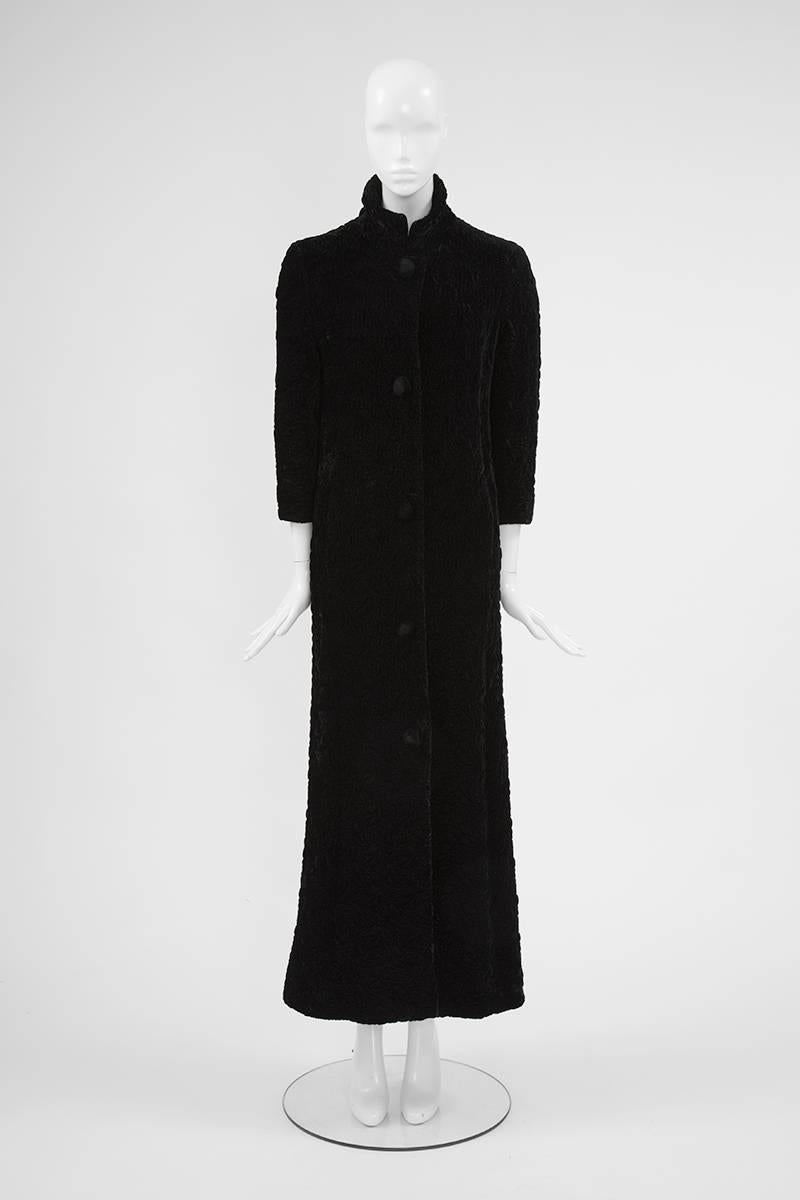 Constructed in sumptuous textured black velvet (see pictures 4, 5 & 7), this 60’s Guy Laroche (distributed by Maria Carine) coat is sharply tailored for a defined linear silhouette. With its standing collar and three-quarter length sleeves, this