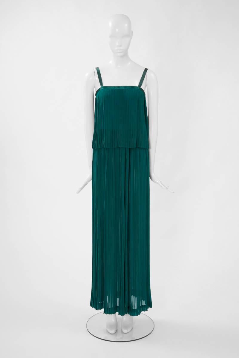 A wonderful addition to any summer wardrobe, this 70's runway Yves Saint Laurent Rive Gauche features a pleated jade green silk chiffon top with a matching elasticated maxi skirt (see picture 5). The top is finished with silk satin edges, used as