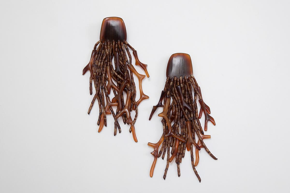 Worldwide known by the use of unusual natural material, Monies is a Danish jewelry company founded in the 70s. These vintage clip-on earrings feature a bunch of tassels and faux coral. Perfect for the fall season, while highlighting them with a