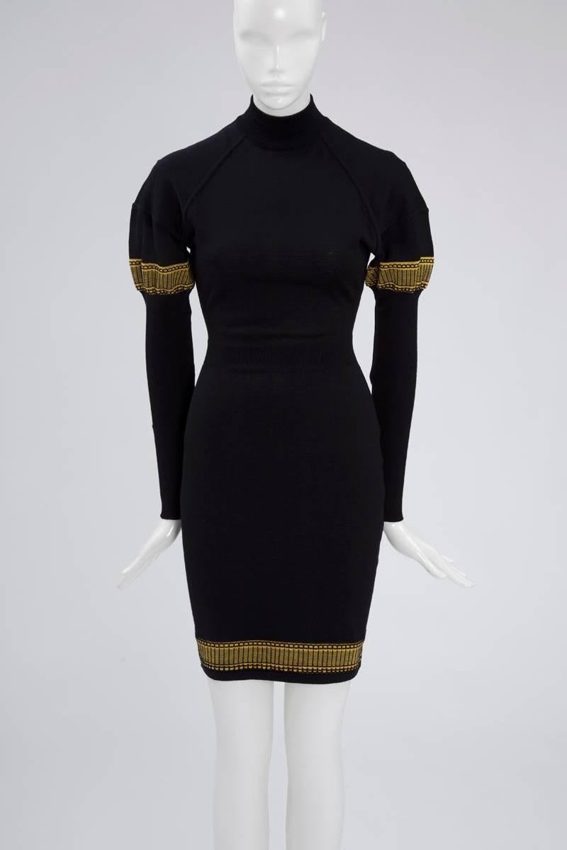 Recognizable and classic 90's Alaia soft wool mini dress. Leg-of-mutton sleeves and high collar. Seam details on the shoulders and yellow borders at the bottom of the dress and on the sleeves. Zip in the middle of the back. Unlined, the dress is a