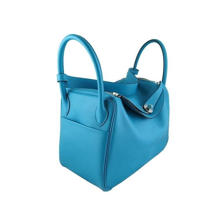 This piece comes complete with original Hermes box, dustbag, rainkit and care card. It is in store fresh condition and kept unused. The bag can be worn on the shoulders or carried on the wrists. Featuring a beautiful azure blue turquoise on swift