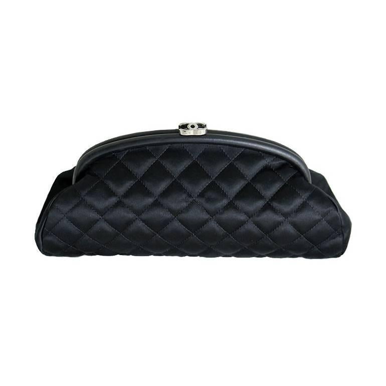 Featuring the iconic timeless classic clutch in black satin fabric. The purse is stain free both inside and out. Interior is clean and odorless. Silver hardware is shiny with no fading or oxidation. It has an inner zippered pocket. Scuffs are