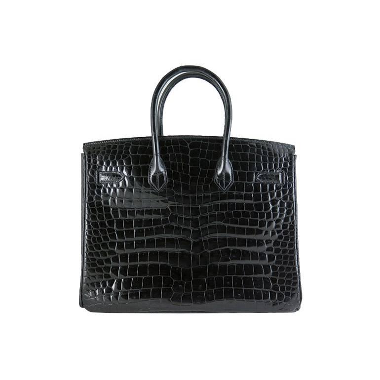 Beautiful combination of black porosus shiny crocodile with palladium silver hardware. Porosus crocodile skin is considered premium and better than niloticus crocodile skin. The bag is clean both inside and out. Features an inner zippered pocket and