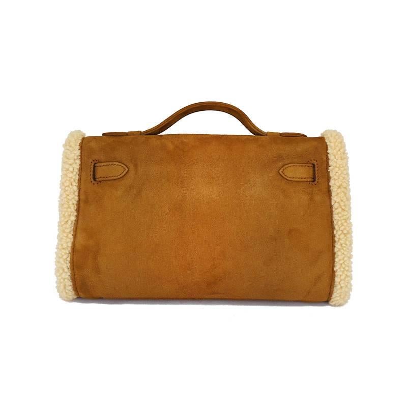 Extremely rare collector's item! The shearling Kelly was sported on the Hermes Fall 2005 Runway. It is in excellent condition, mostly kept unworn. Protective plastic is still on the hardware. There is an interior pocket. It can be worn as a muff or