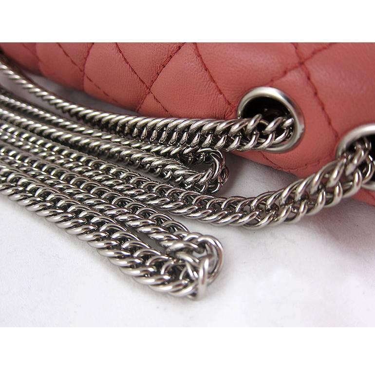 Chanel has discontinued it's East West flap. Rarely available in this color with bijoux chain and bicolor leather. The chains can be worn long or doubled on the shoulders. There are no visible stains or scratches on the exterior lambskin leather.