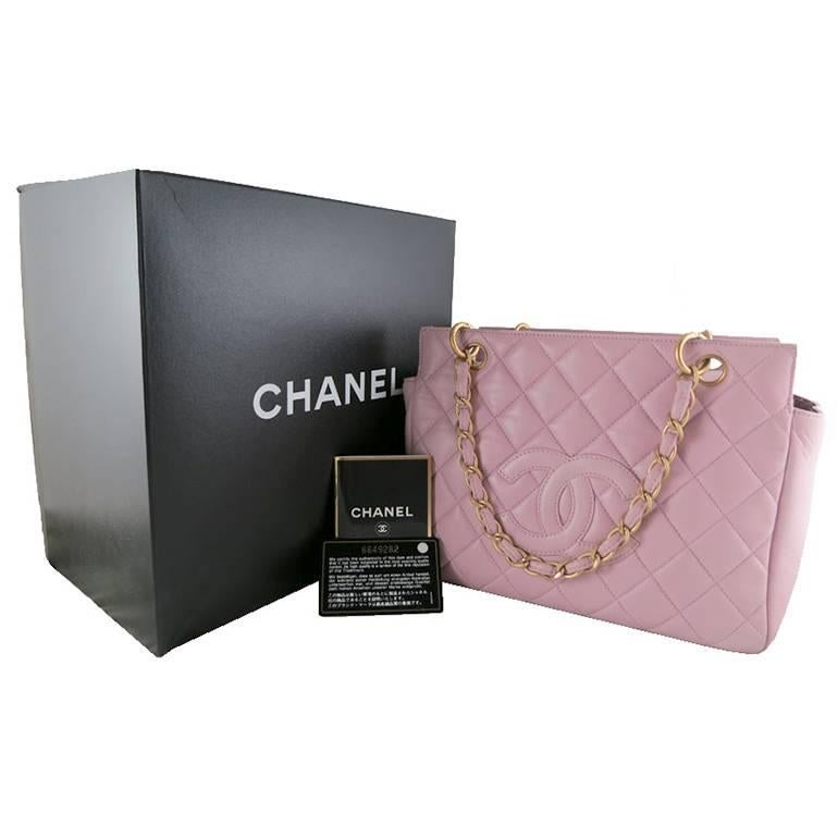 Rarely available in dual tone pink lambskin exterior and purple interior. This piece comes complete with original Chanel box, authenticity card and care booklet. It is without stains or scratches on the exterior. Gold chains and hardware are shiny