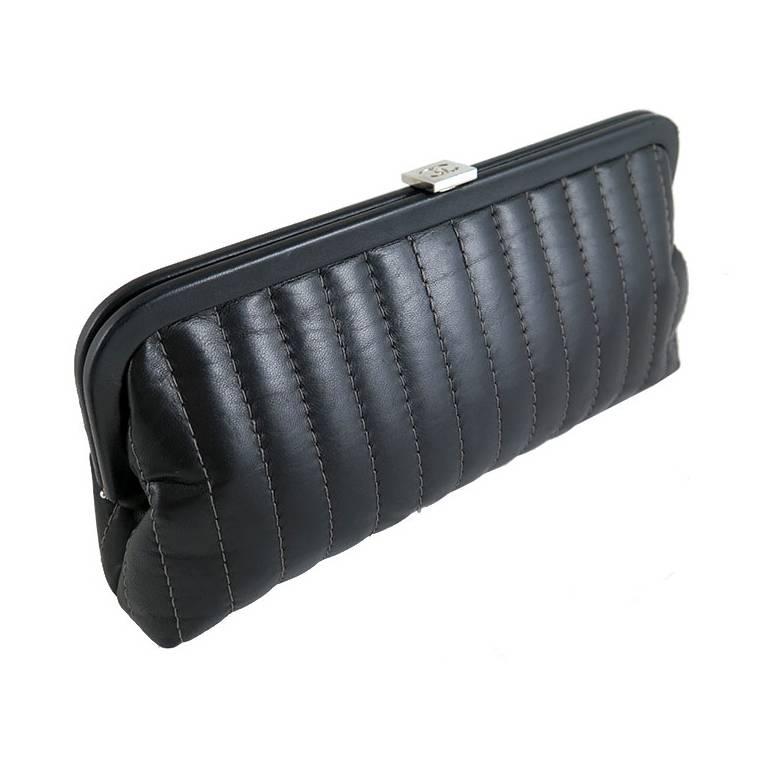 The mademoiselle clutch was a seasonal item and was never reproduced again. This piece is well kept and in excellent condition. Features black lambskin leather exterior and black camellia fabric interior. There is an inner slot pocket. Silver CC