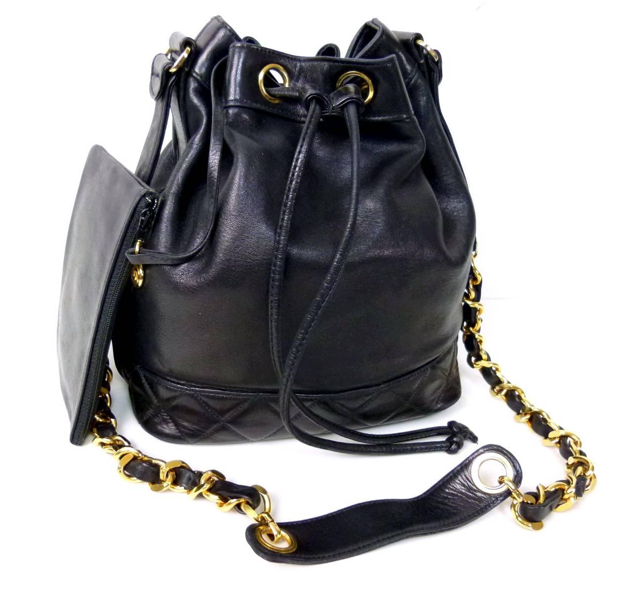 This vintage drawstring shoulder tote has been discontinued by Chanel. Comes attached with black lambskin pouch. Some wrinkles and superficial scratches present on the leather. Gold chains and hardware are shiny with no fading. Minor rubs present on