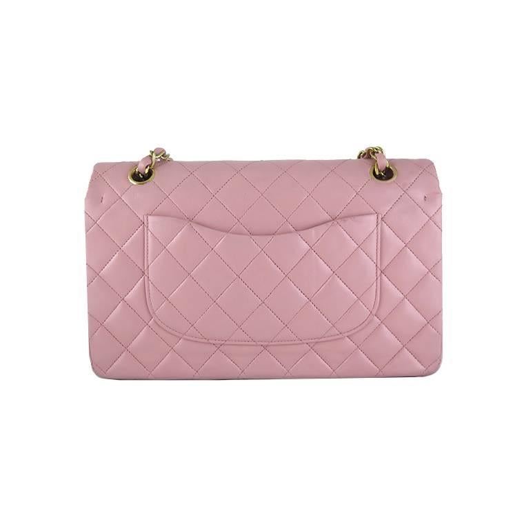 Rarely available in pink! This piece comes complete with original Chanel box, dustbag and authenticity card. There are no visible stains or scratches on the exterior leather. Gold chains and hardware are shiny with no fading or oxidation. Interior