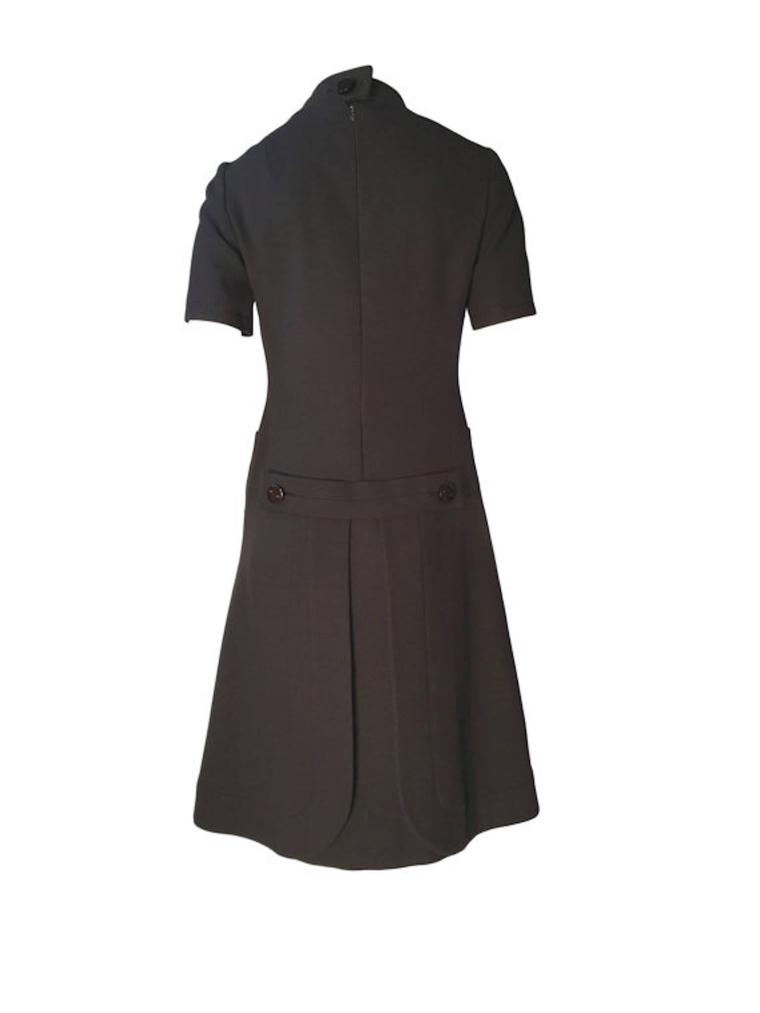 Jean Patou brown wool vintage 1960s mod dress. Made from heavy woven wool, fully lined, superb space age design with back panels and button detail, still has a spare button inside. Fastens at the back with zip and button at back neck.

Size UK