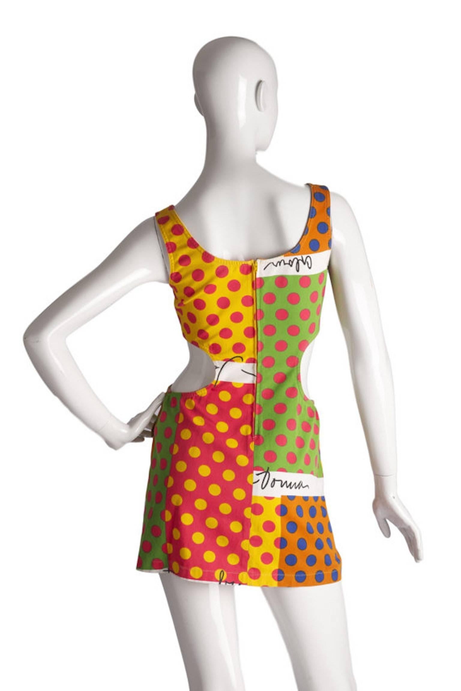 
Moschino Jeans vintage mid 90s cut out design mini dress. Brightly coloured and mixed print in cotton, with zip back fastening.

Size UK 8 measures 16.5 inches across bust and 30.5 inches length. 