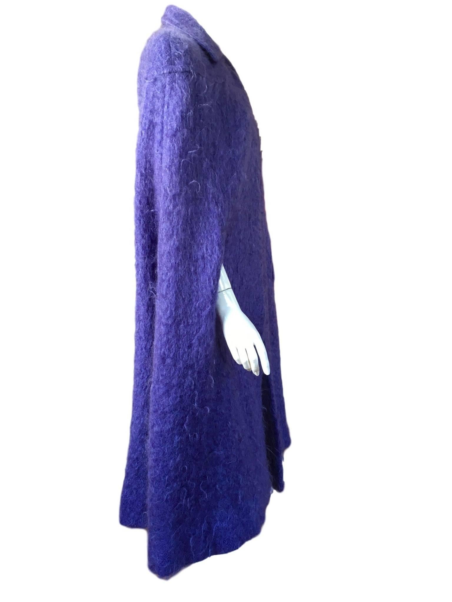 Murray Arbeid vintage 1970s lavender soft mohair cape, with popper neck fastening and has arm holes.

Size small to medium measures 18 inches across shoulders and 47 inches length from top of collar to hem.