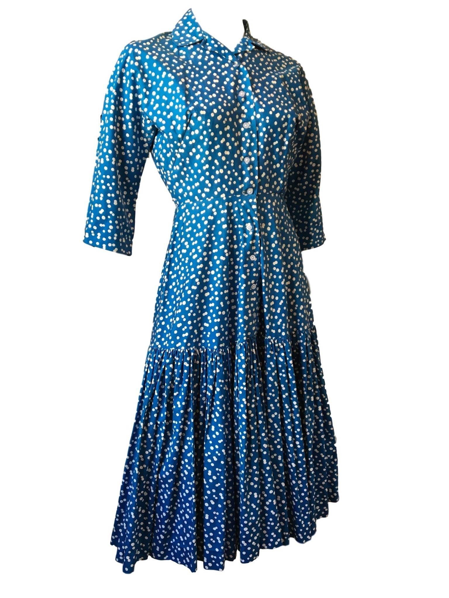 Original Horrockses blue and white polka dot dress, with dropped waist, cropped sleeves and button front fastening, has belt loops but no belt remains. 

Size 8 measures 16 inches across bust 12.5 inches across waist and 48 inches length.