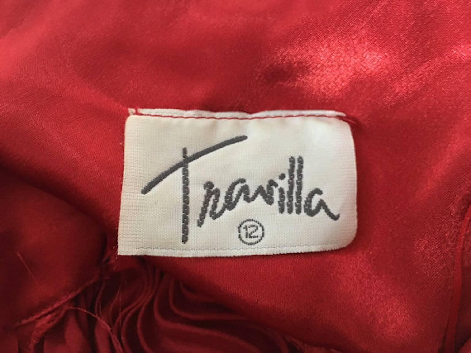 William Travilla Red Satin Pleated Cocktail Halter Dress. 

A design of the dress worn by Marilyn in The Seven Year Itch. 

Made in the late 1970s. 

Made from satin polyester

Fastens with a back zip.

Size UK 8/10 Measures 17.5 inches