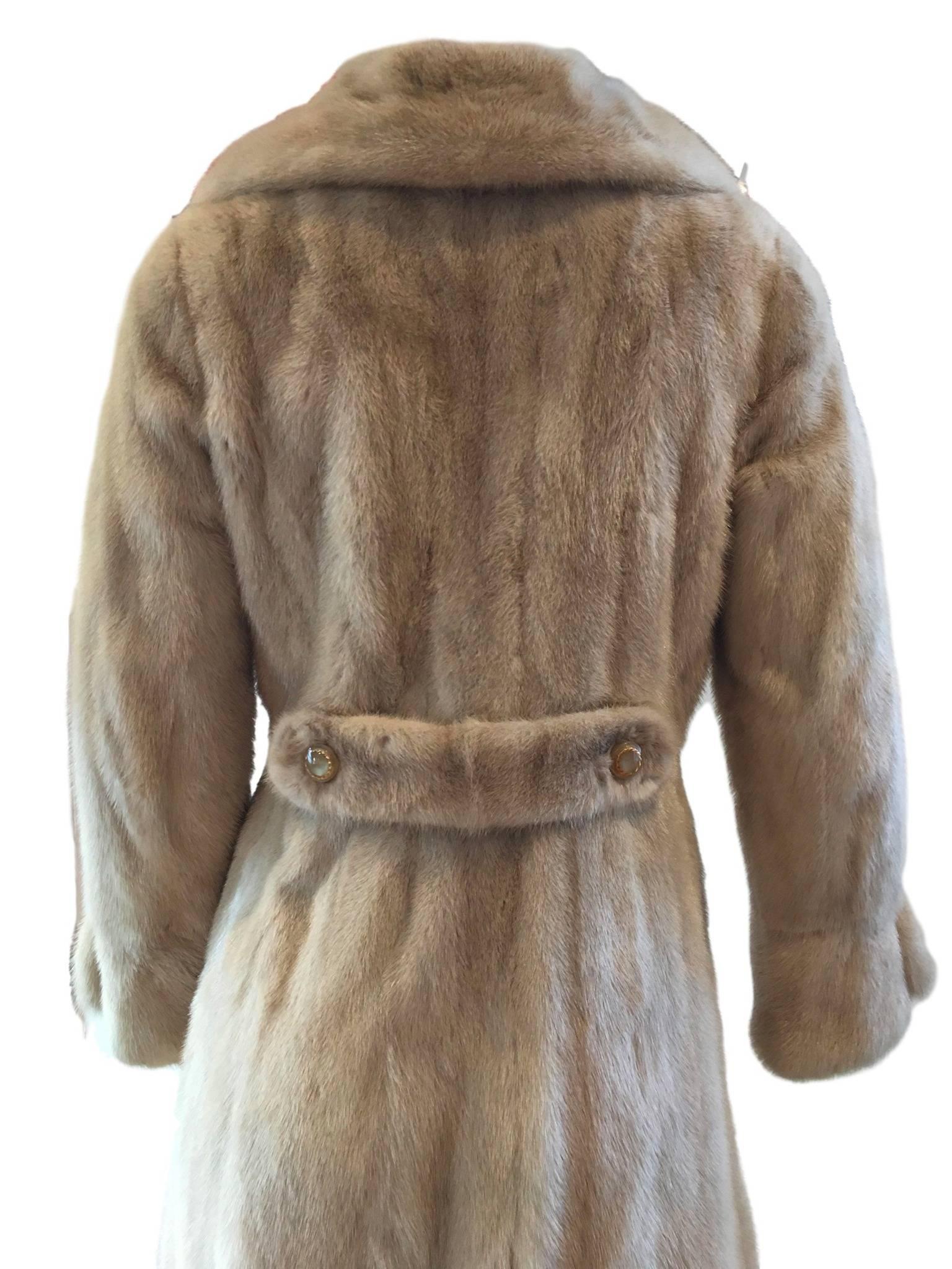 Vintage 1970s real blonde mink fur coat, satin lined and has an optional belt feature. The fur is soft and in superb condition. 

Size Uk 8. Measures 17 inches under arm to under arm, 14 inches across waist and 44 inches length from shoulder to