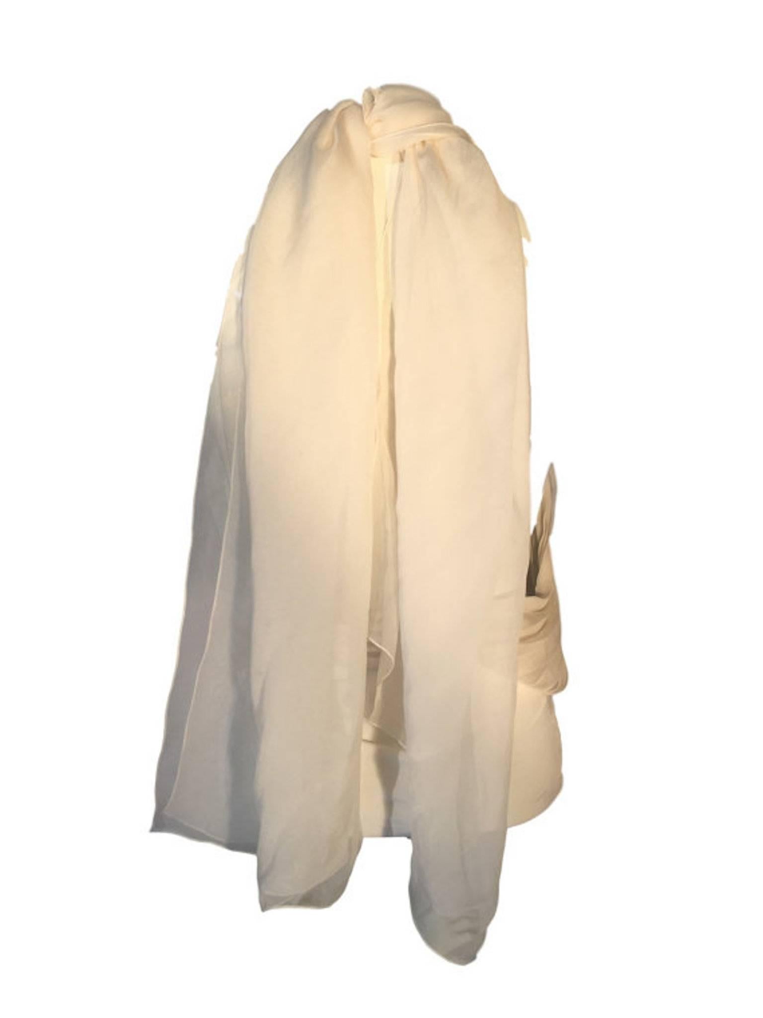 Beautiful Gianfranco Ferre Cream Chiffon Top. Made from silk and has pleated detail. With long neck sash that ties at the back of the neck. Elasticated waist section.

Labelled a 38 Size UK 8 measuring 13 inches across waist band and 28 inches