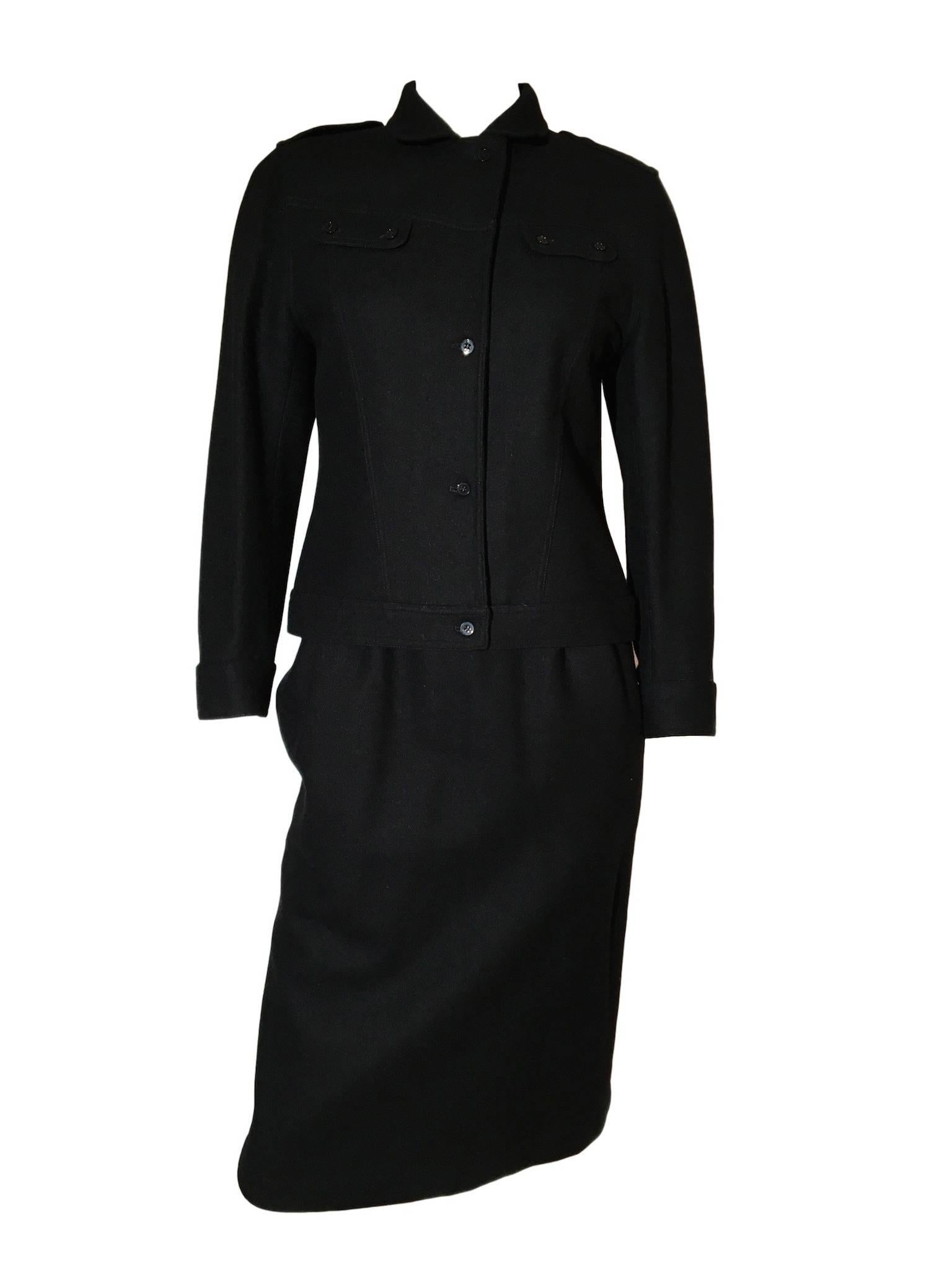 Enrico Coveri black wool skirt and jacket suit, jacket has a military look to it, skirt is high on waist, fitted and just above knee length, it fastens with buttons only, a vert unusual but clever feature.

Size UK 8 Measures 17 inches across bust