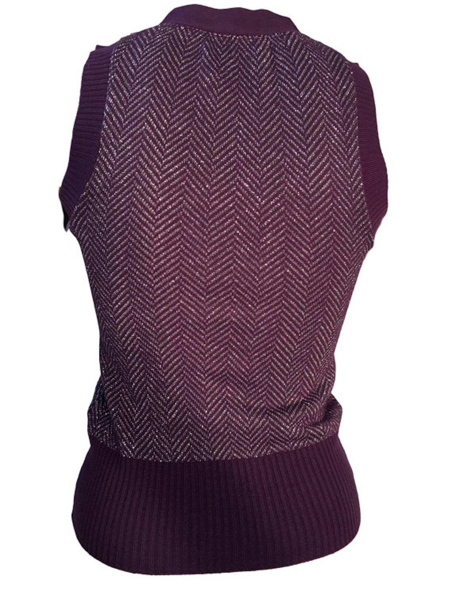 Original vintage Biba purple and silver herringbone knitted tank top/sleeveless cardigan. With button fastening.

Size UK 6 measures 14 inches across bust and 22 inches length. 

Excellent condition