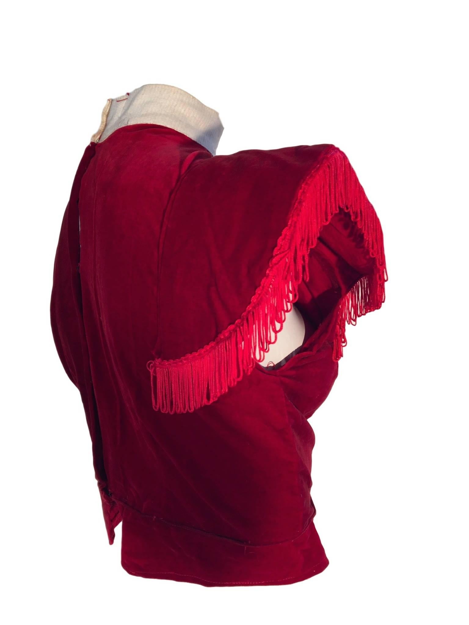 Original 1950s red velvet Show Girl/Burlesque top, with lampshade shoulders with tassel trim, fastens at the back with hook/eye closures and has a white cotton collar top. 

In very good condition considering its use and it is a handmade unlined