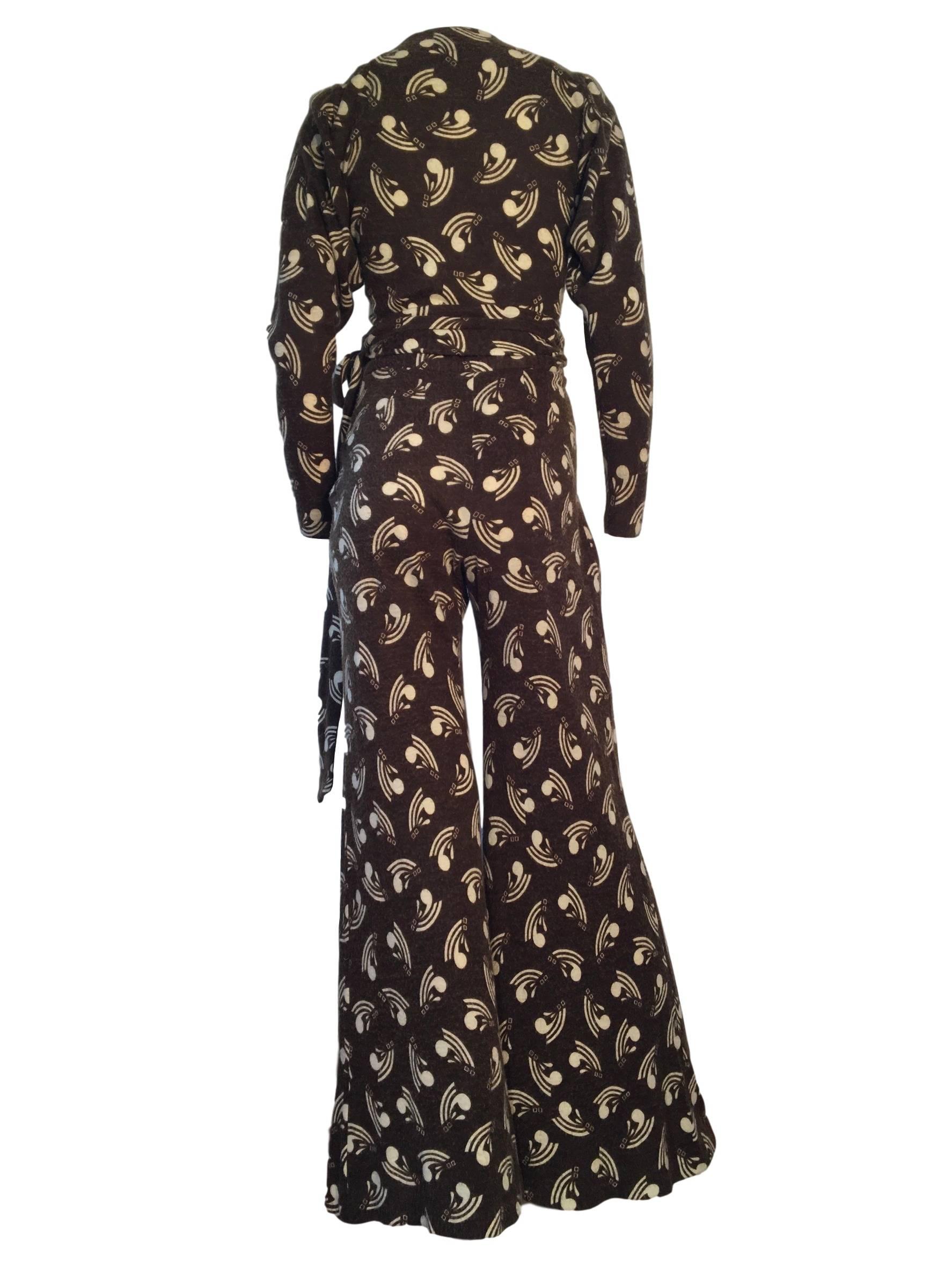 Vintage original Biba 2 piece, flares and wrap top made from a textured wooly like material. With deco style print, the top has wrap feature fastening, slight shoulder pads and fitted sleeves. Trousers have high waist and flared leg and fasten with