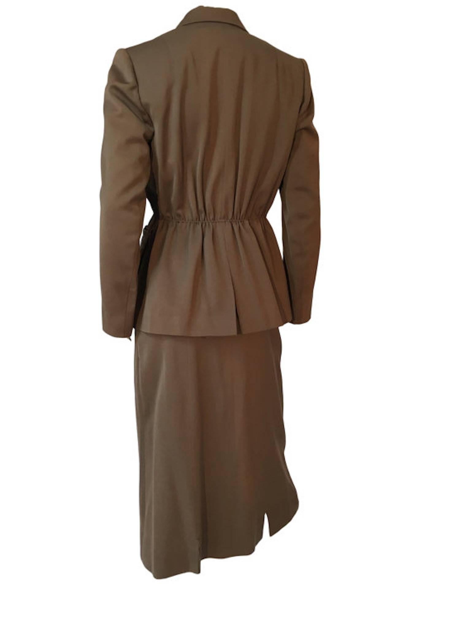 Gilbert for Bests Apparel wool skirt suit, beautifully tailored jacket with interesting pocket detail. Structured sharp shoulders and nipped in waist, skirt is calf length and fastens at the sid with original metal zipper and hook/eye closure.

Size