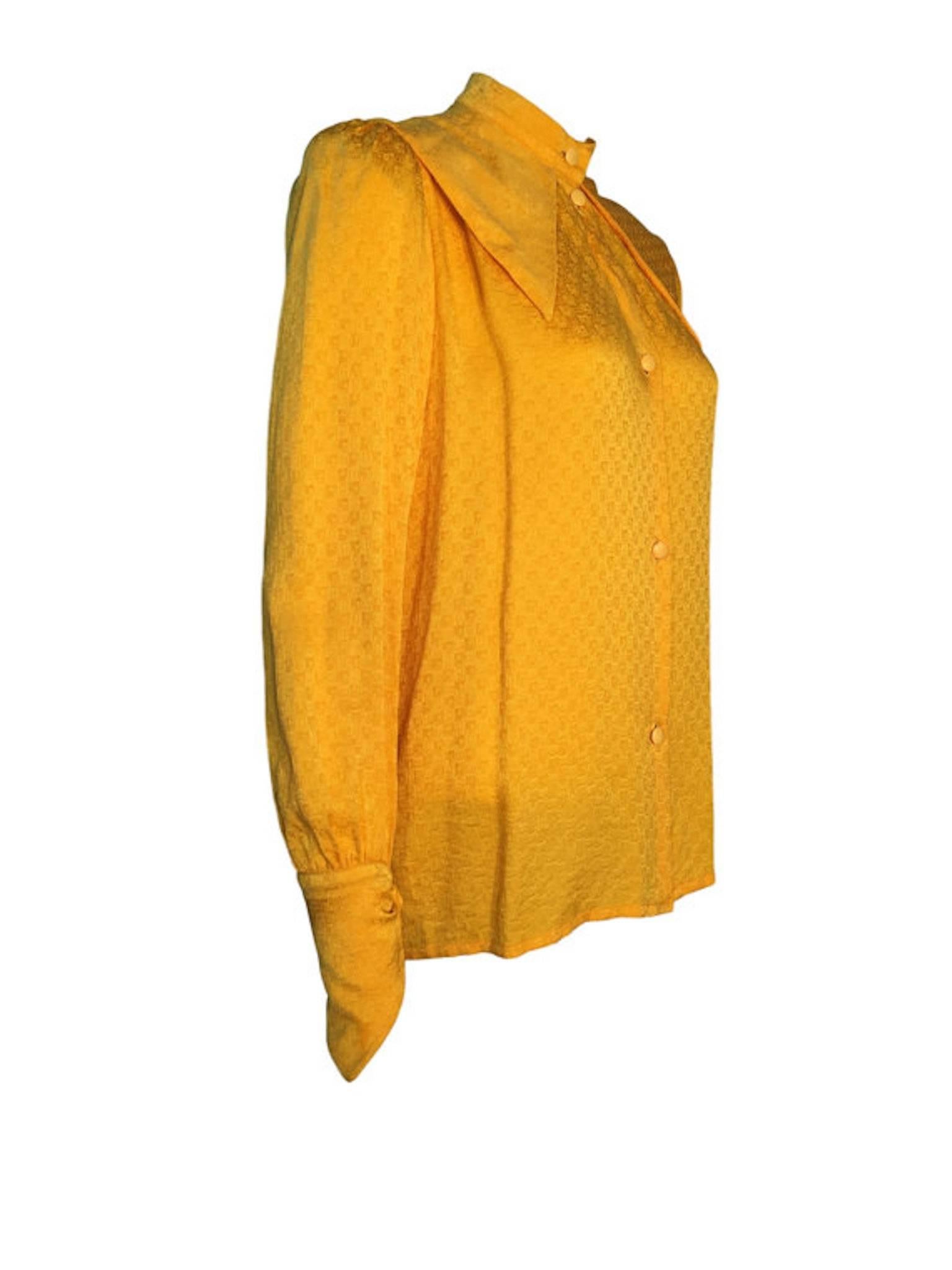 Christian Dior 1970s yellow silk monogrammed blouse, button front, has large collar detail and pointed detail on cuffs.

Size UK 10 Measures: 19 inches across bust and 26 inches length, sleeve measures shoulder seam to cuff 21 inches.

Very good