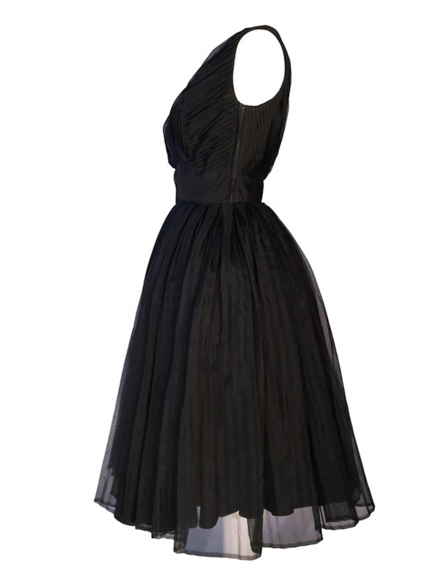 Jean Allen Early 1960's black chiffon fit and flare evening cocktail dress. Skirt constructed of 5 layers of different materials to give volume. Fastens at the left side with a metal zip.

Size UK 8/10 measures just under 18 inches across bust, 14
