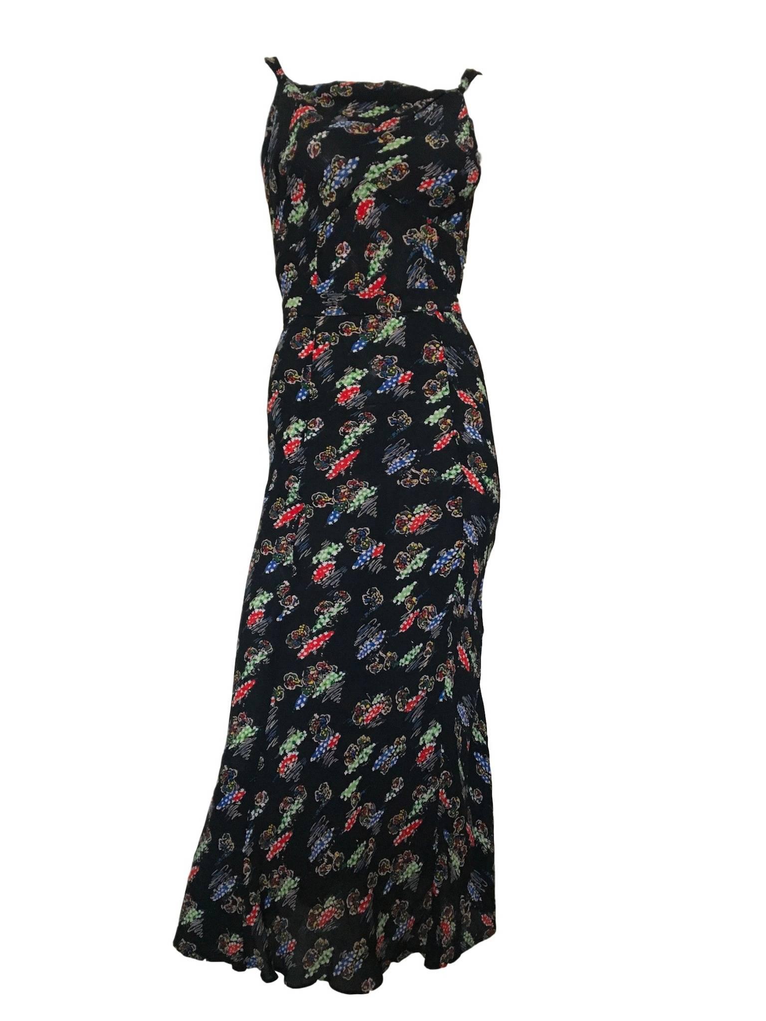 Vintage 1930s Bourne & Hollingsworth black crimped silk crepe material with colourful novelty print of trees with flowers, has matching belt and bolero that fastens at the front with a double sided button. An exceptional original piece, the material