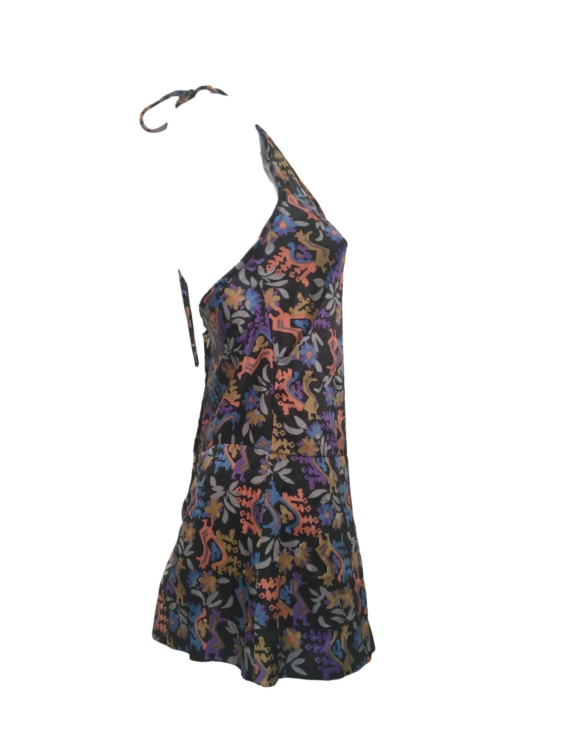 Vintage satin halter neck romper/playsuit by Clobber (Jeff Banks) With mythical print and back zip fastening.

Size UK 8/10. Measuring 16 inches across bust 14 inches across waist and 38 inches length

In excellent condition.

Available worldwide,