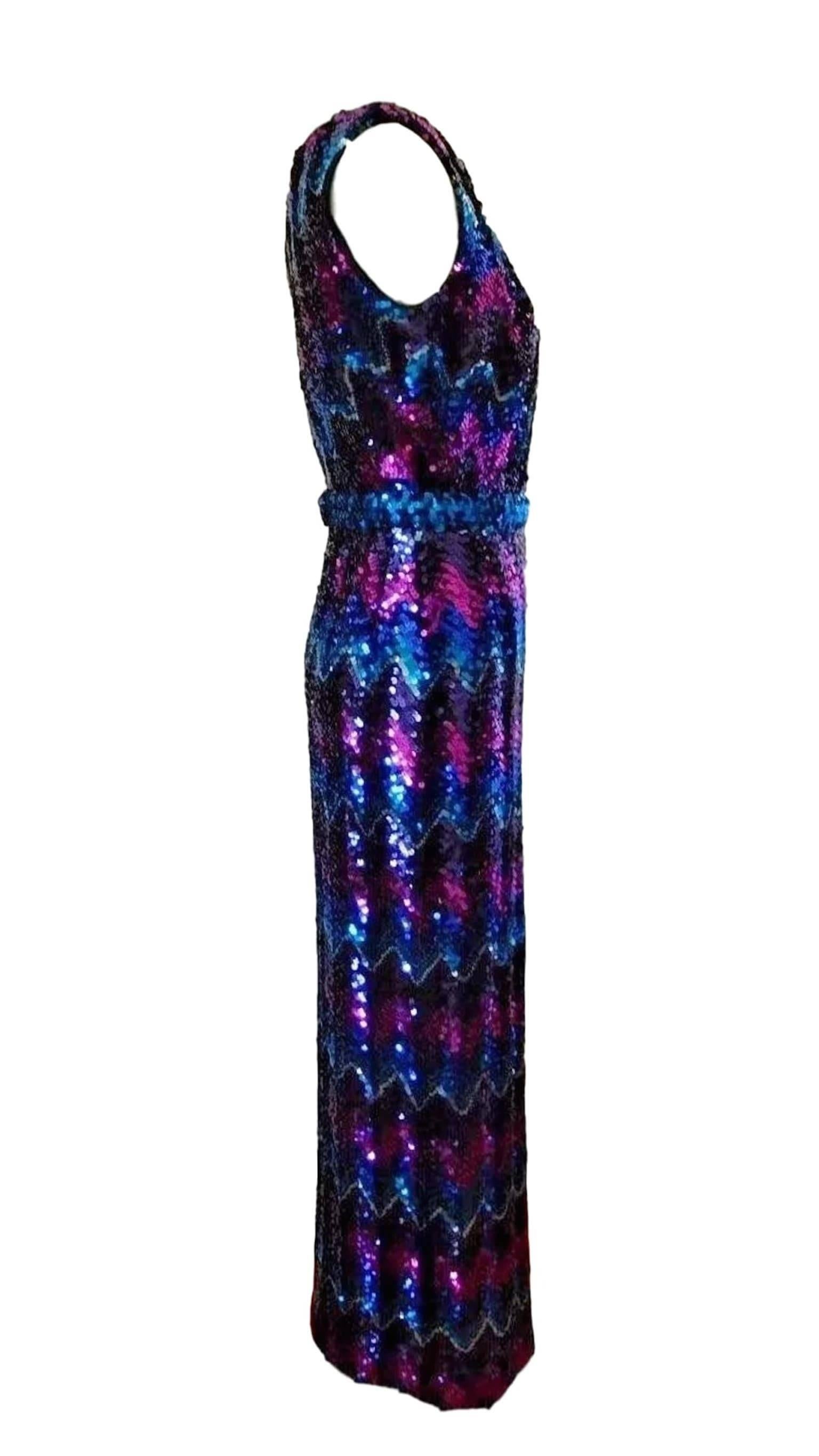 An unlabelled 1970s disco eras one shoulder maxi dress, fabulous piece! with chevron sequins in purples and blues. Strong sturdy piece and in excellent condition.
Measures bust waist and length
