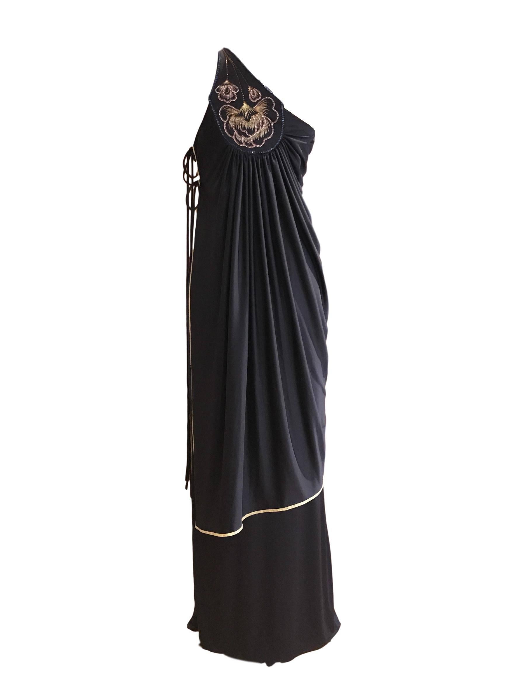Superb Bill Gibb 2 piece jersey toga set. Maxi skirt and tunic with side fastening. Gold metallic trim and beaded feature in front and back. 
Skirt measures 26 waist and 42 inches length, tunic is 32 bust and 40 inch length.
Excellent condition 
